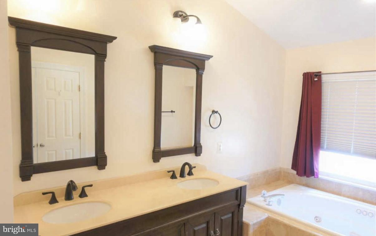 1847 Brenthill Court Vienna, VA 22182 - Photo 11 of 26 a bathroom with a sink and a mirror