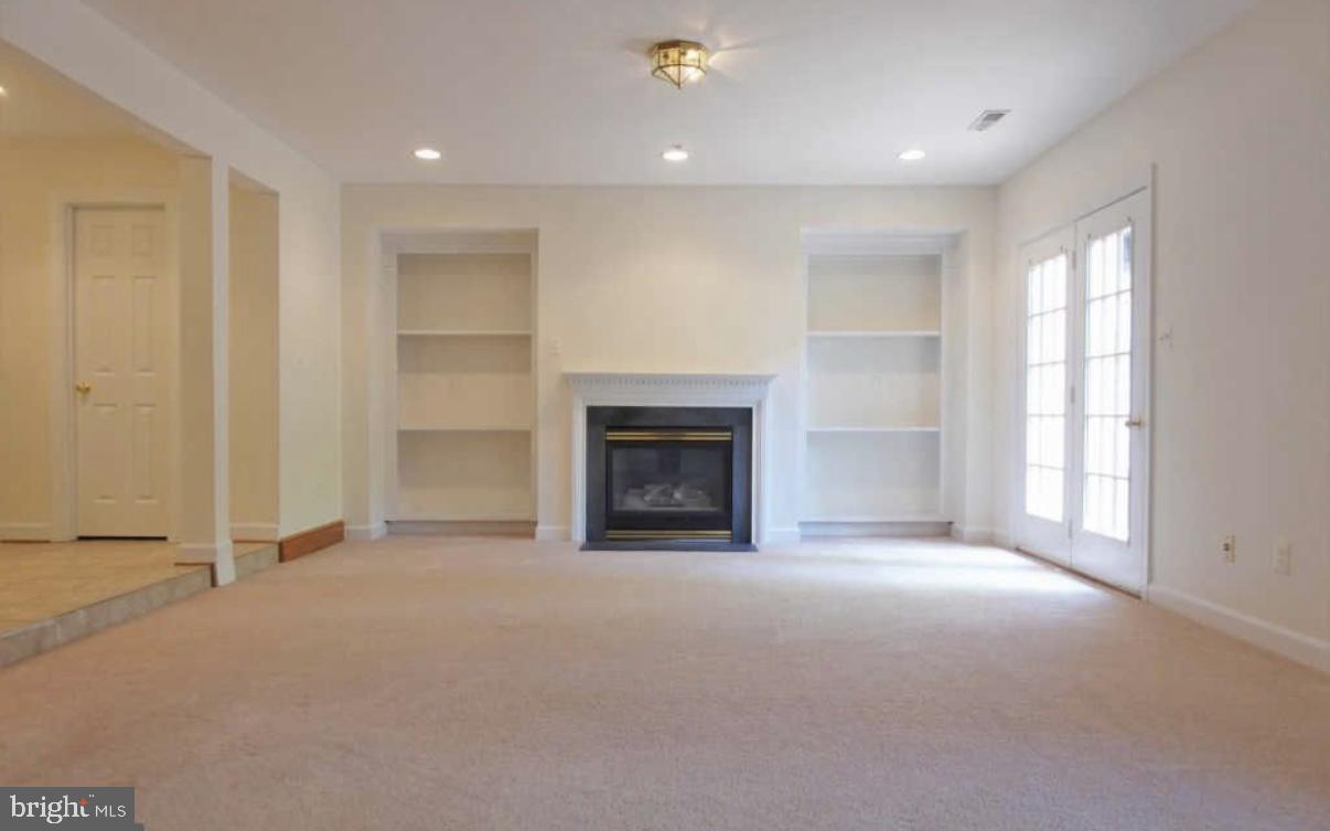 1847 Brenthill Court Vienna, VA 22182 - Photo 17 of 26 an empty room with windows and fireplace