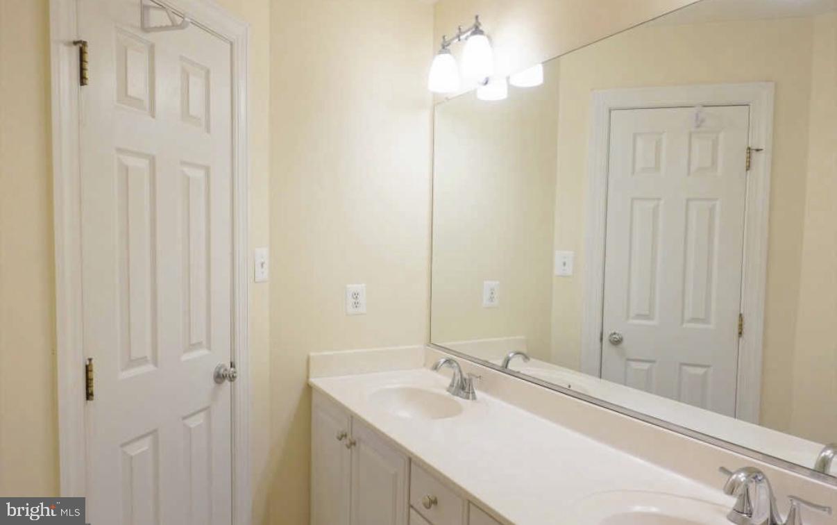 1847 Brenthill Court Vienna, VA 22182 - Photo 19 of 26 a bathroom with a sink vanity and a mirror