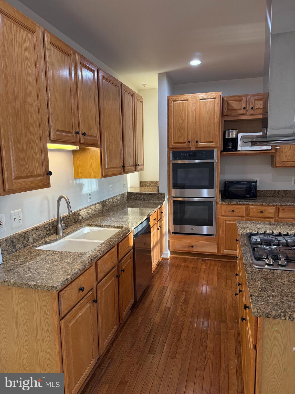 1847 Brenthill Court Vienna, VA 22182 - Photo 7 of 26 a kitchen with stainless steel appliances granite countertop a stove a sink and a microwave