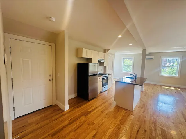 a view of kitchen with furniture and wooden floor