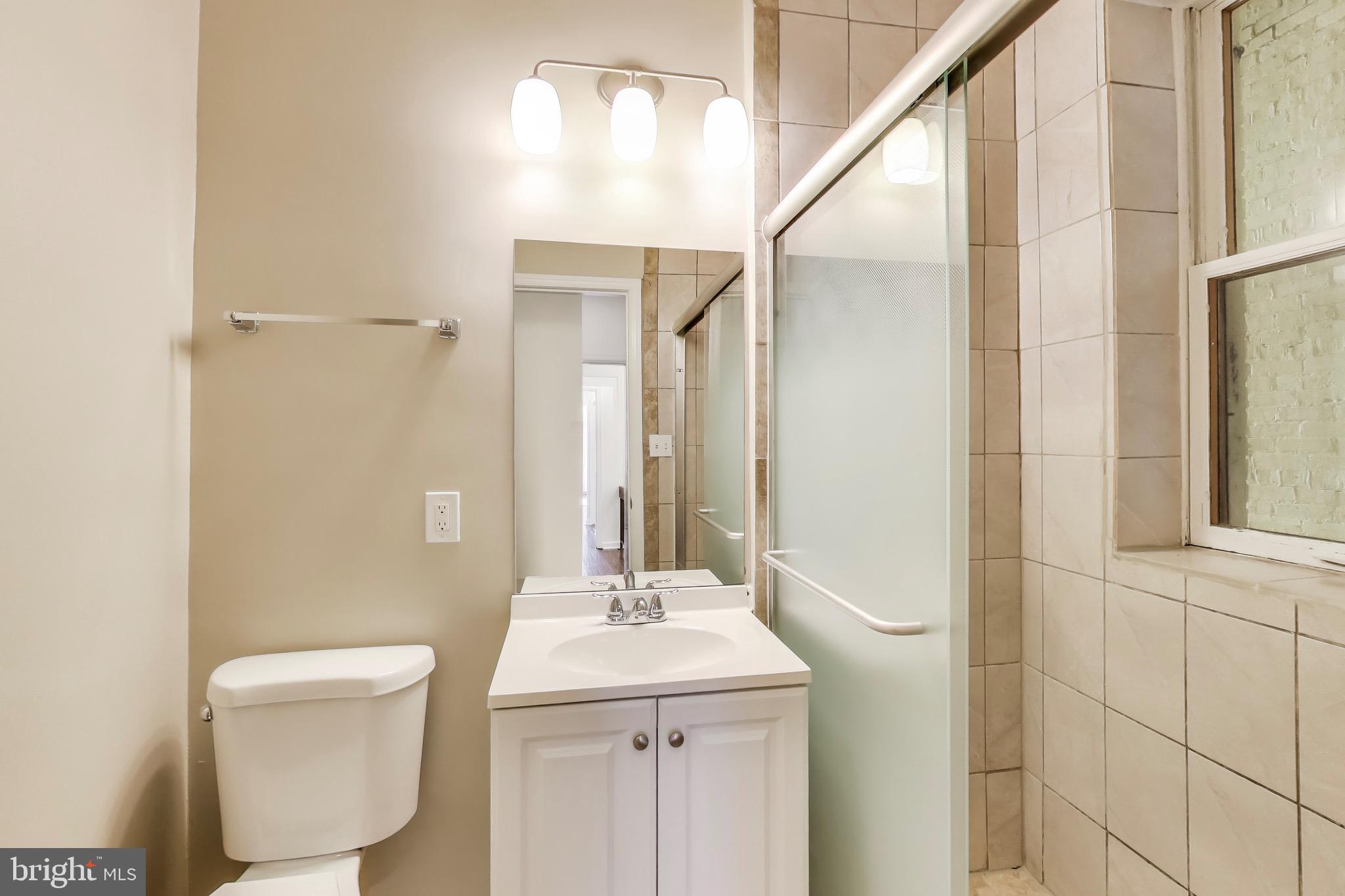 1625 S Street Northwest, Unit 1 Washington, DC 20009 - Photo 12 of 13 a bathroom with a sink a toilet and shower