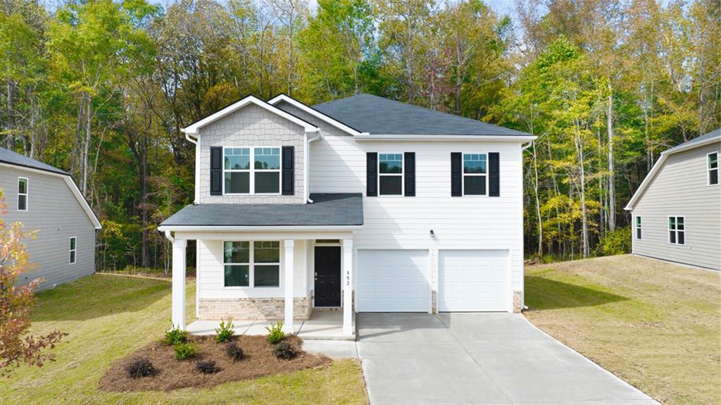 330 Friendship Oak Way Hampton, GA 30228 - Photo 1 of 41 a front view of a house with a yard