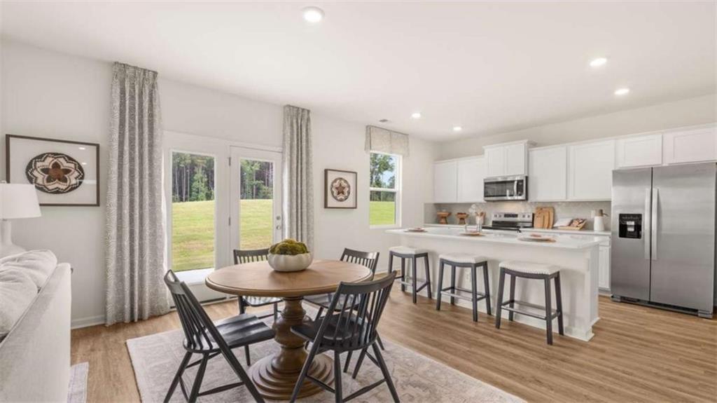 330 Friendship Oak Way Hampton, GA 30228 - Photo 13 of 41 a view of a dining room with furniture and wooden floor