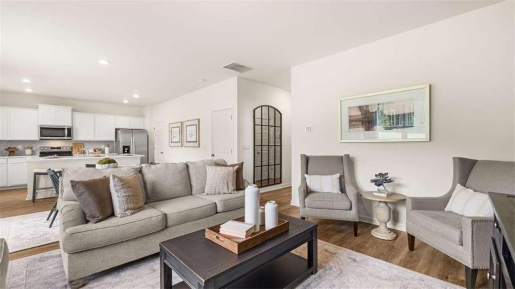 330 Friendship Oak Way Hampton, GA 30228 - Photo 15 of 41 a living room with furniture kitchen view and a potted plant
