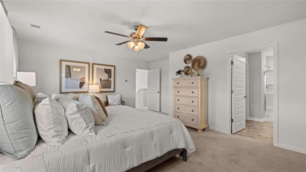 330 Friendship Oak Way Hampton, GA 30228 - Photo 20 of 41 a bedroom with a bed and a chandelier