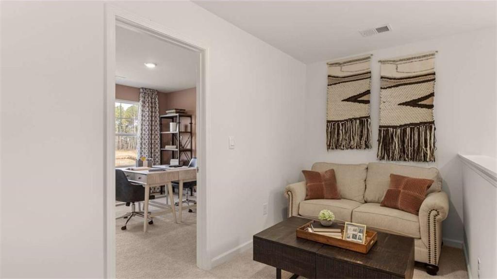 330 Friendship Oak Way Hampton, GA 30228 - Photo 26 of 41 a living room with furniture a lamp and a potted plant