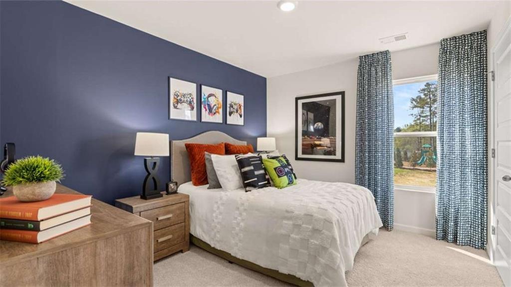 330 Friendship Oak Way Hampton, GA 30228 - Photo 31 of 41 a bedroom with a bed and a painting on the wall