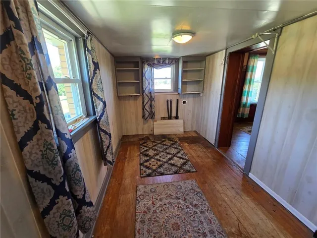 a view of entryway with furniture and wooden floor