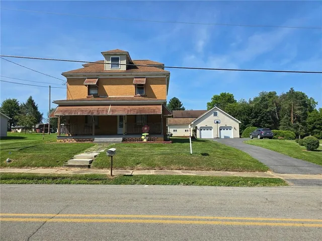 a front view of a house with a yard