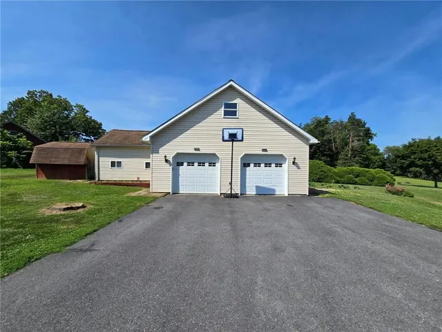 a view of a house with a yard and garage