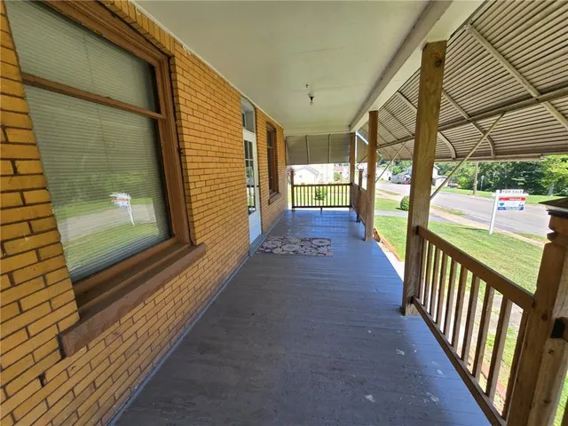 a view of a balcony with wooden floor