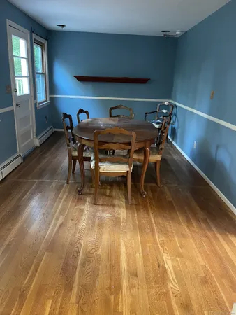 a view of a dining room with furniture and window