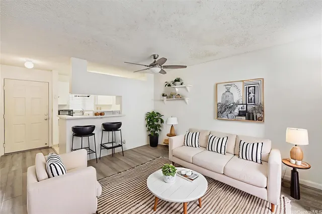 a living room with furniture and wooden floor