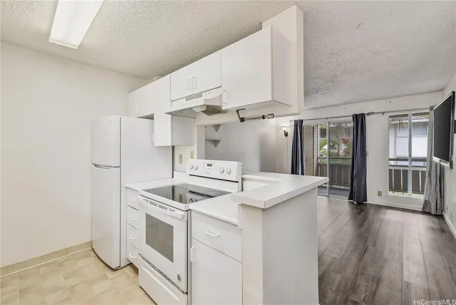 a kitchen with cabinets and stainless steel appliances