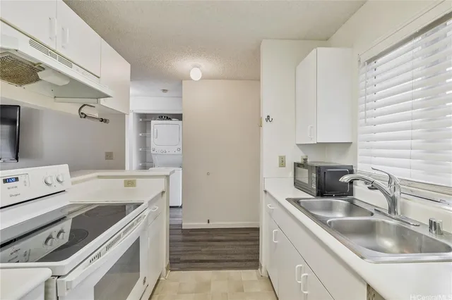 a kitchen that has a sink and a stove
