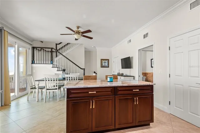 a view of living room with furniture and a ceiling fan