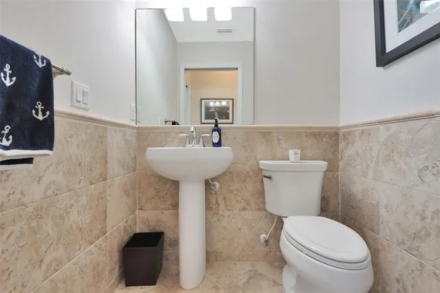a bathroom with a sink toilet and mirror