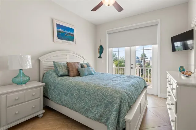 a bedroom with a bed and large window