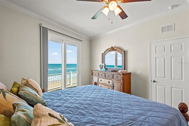 a bedroom with a bed and dresser with mirror