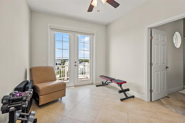 a living room with furniture gym equipment and a rug