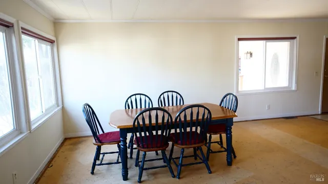a view of a dining room with furniture and window