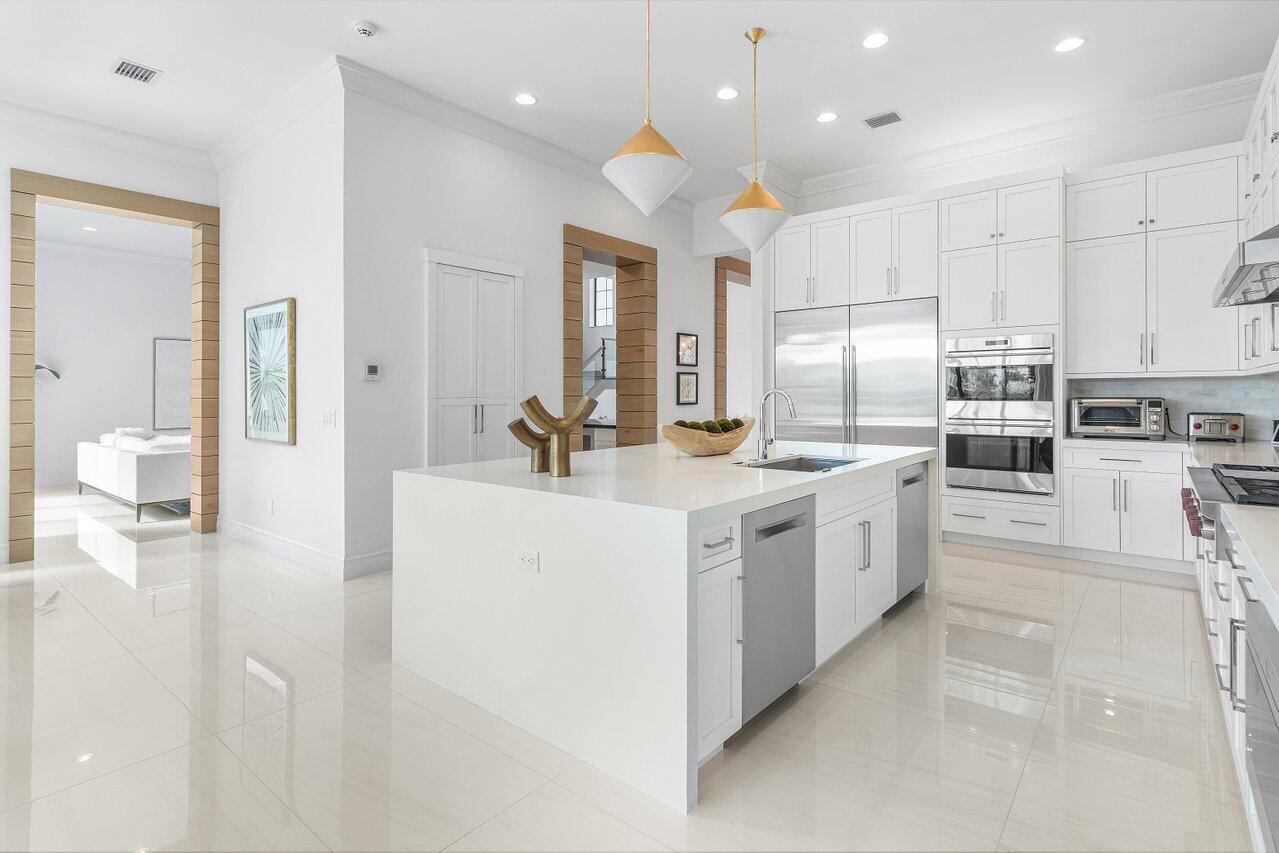 9276 Biaggio Road Boca Raton, FL 33496 - Photo 20 of 70 a kitchen with white cabinets and white appliances