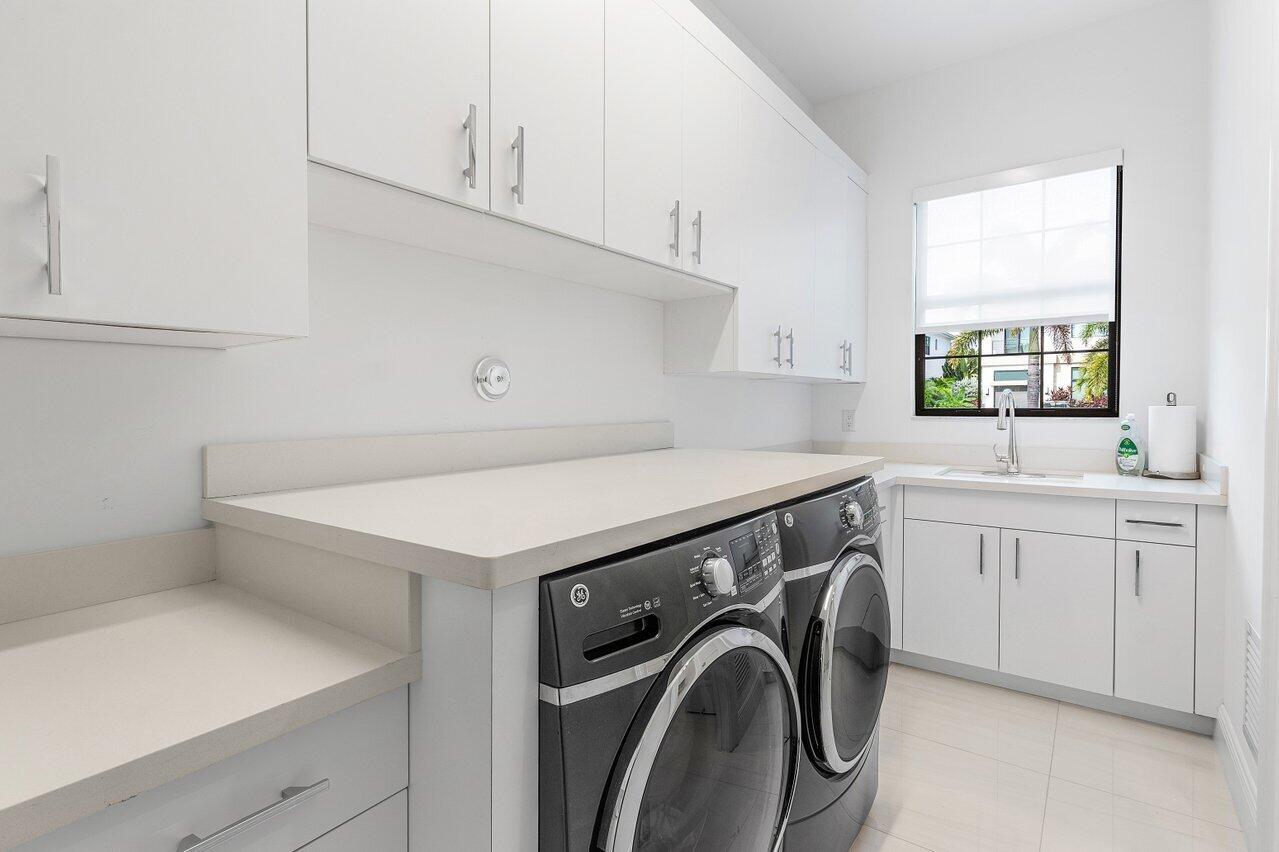 9276 Biaggio Road Boca Raton, FL 33496 - Photo 27 of 70 a utility room with sink dryer and washer
