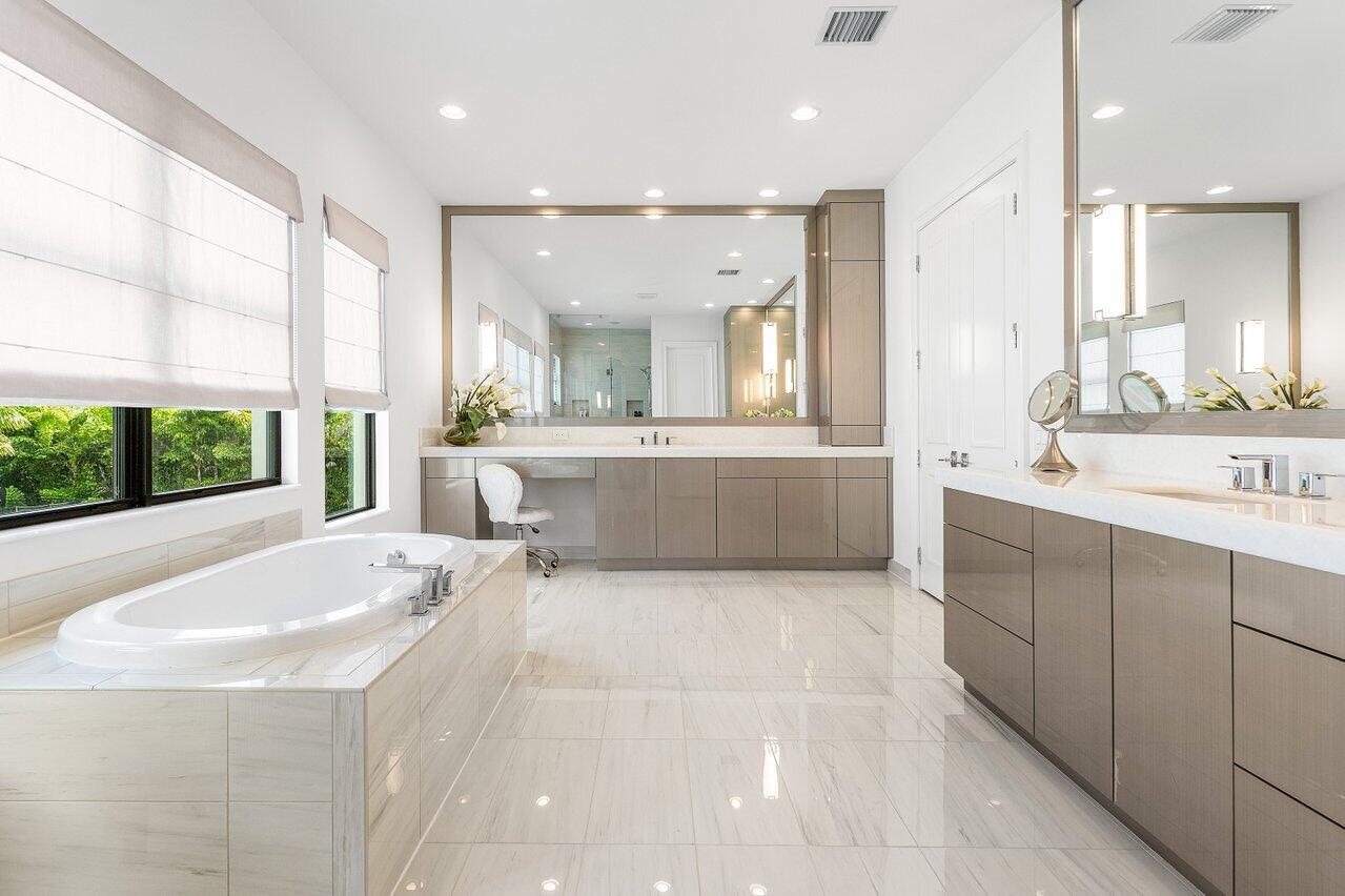 9276 Biaggio Road Boca Raton, FL 33496 - Photo 42 of 70 a large white bathroom with a large tub sink and vanity