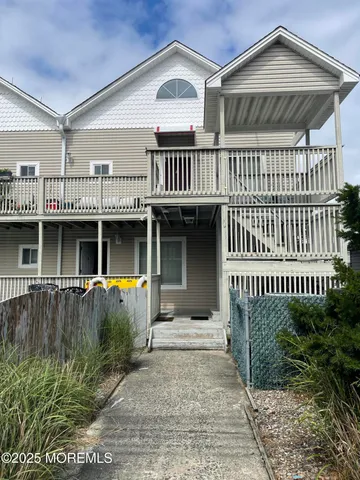 a front view of a house with a garden and deck