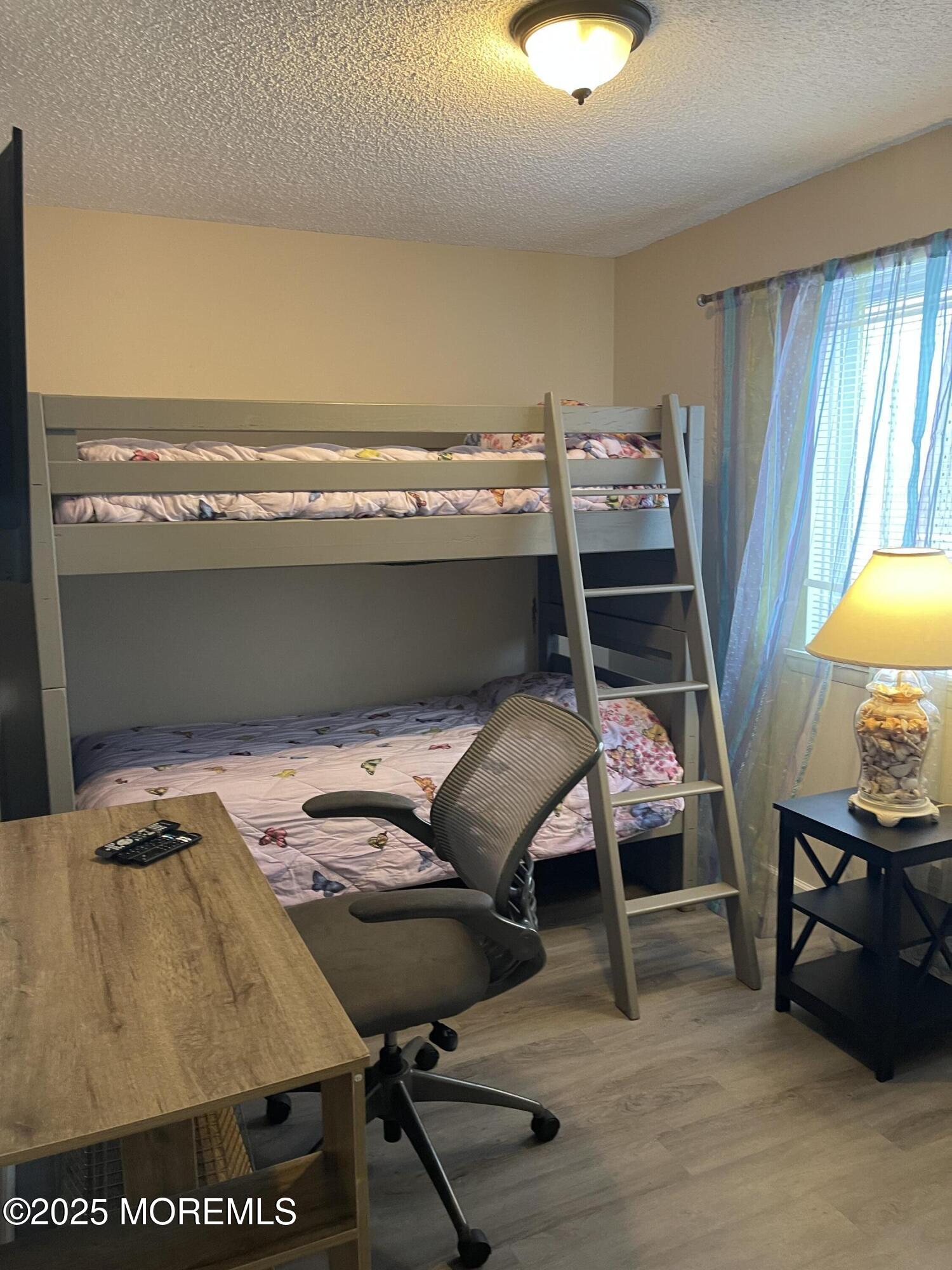 202 Carteret Avenue, Unit A2 Seaside Heights, NJ 08751 - Photo 12 of 15 a balcony with a table and chairs