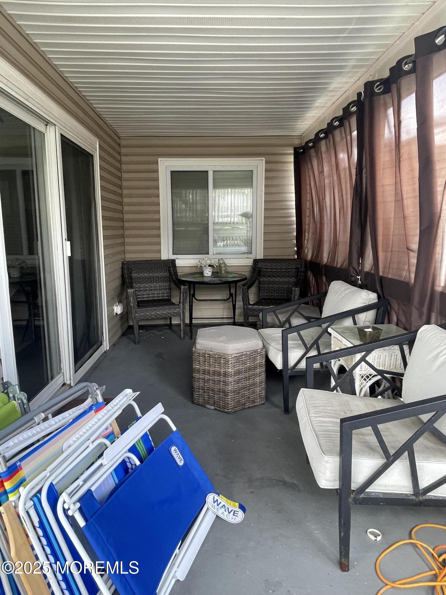 202 Carteret Avenue, Unit A2 Seaside Heights, NJ 08751 - Photo 14 of 15 a living room with furniture and a window