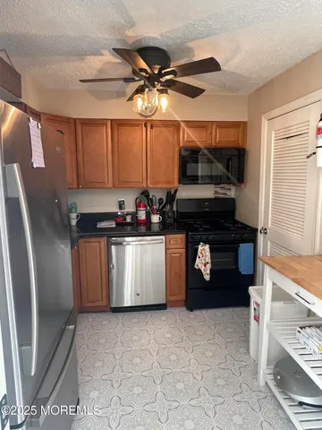 a kitchen with stainless steel appliances a refrigerator and a stove