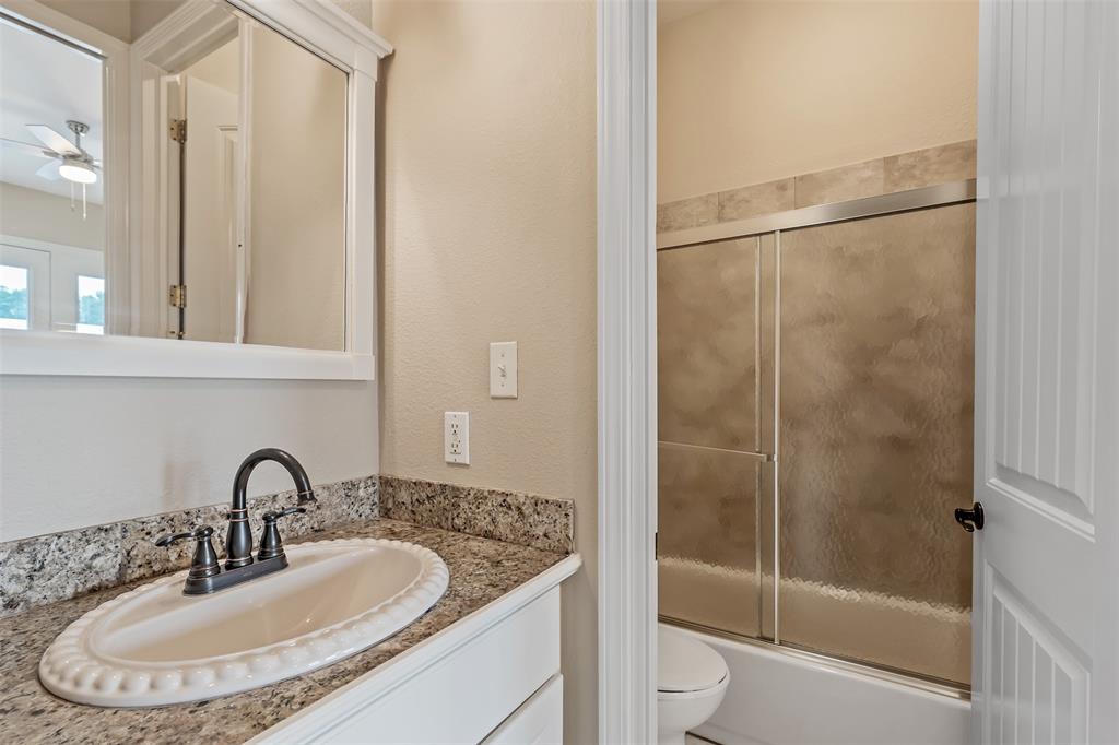 20389 County Road 178 Flint, TX 75762 - Photo 21 of 40 Bathroom vanity with a granite countertop, undermount sink, and dark bronze faucet