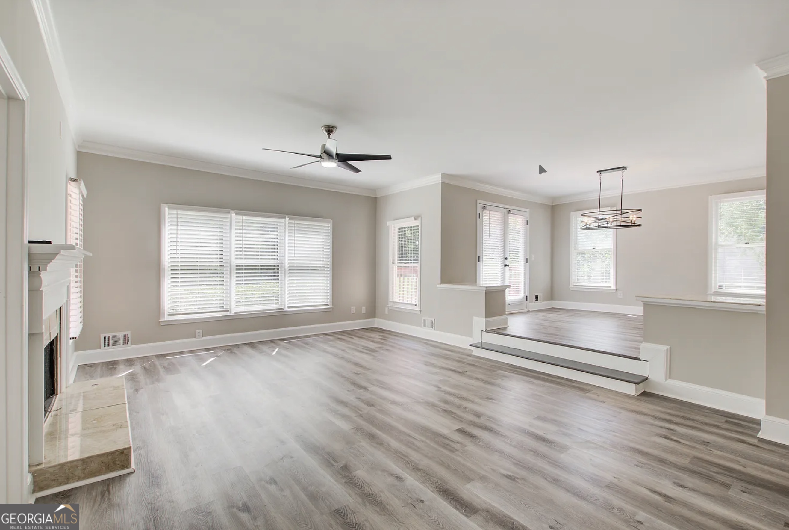 3 South Riversong Lane Alpharetta, GA 30022 - Photo 2 of 7 an empty room with wooden floor and windows