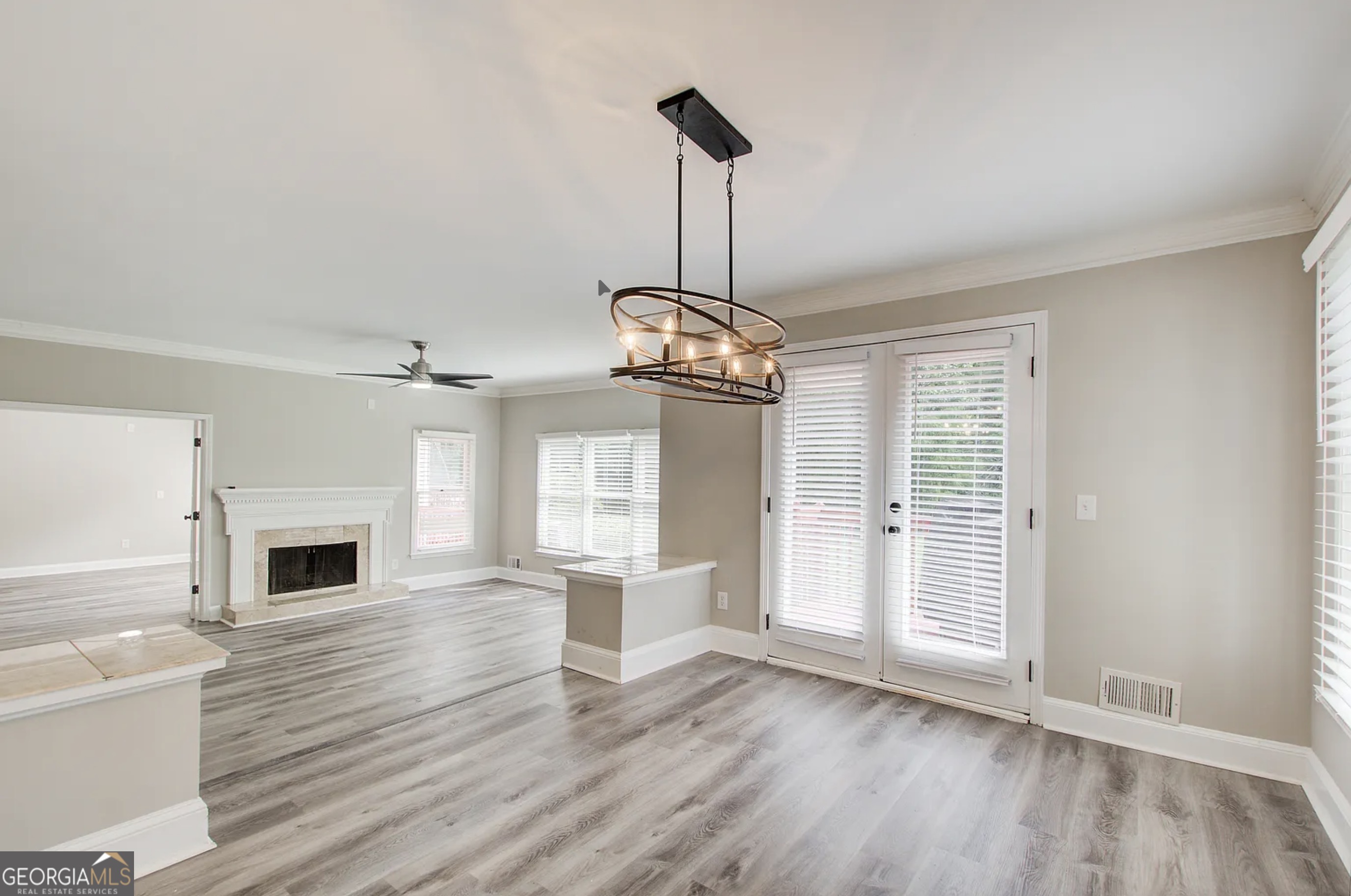 3 South Riversong Lane Alpharetta, GA 30022 - Photo 3 of 7 a view of a livingroom with wooden floor a fireplace and windows