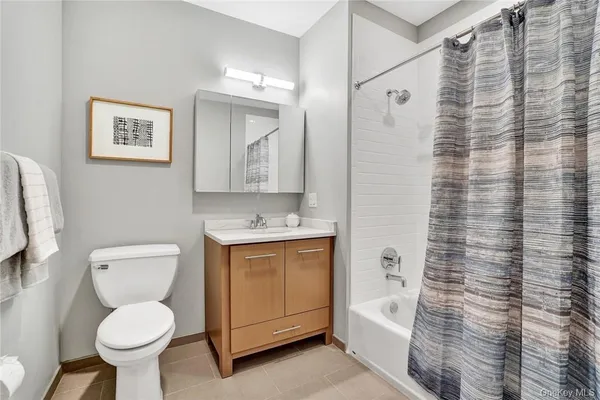 a bathroom with a toilet sink and shower