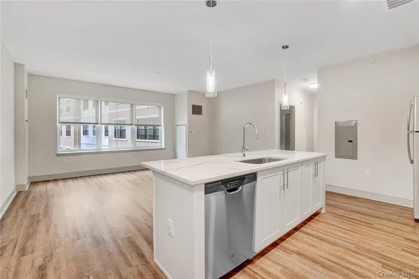 a view of a kitchen counter space and wooden floor