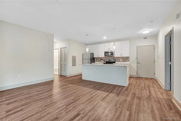 a view of kitchen with wooden floor and window
