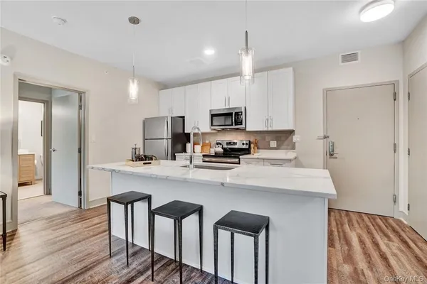 a kitchen with kitchen island cabinets and wooden floor
