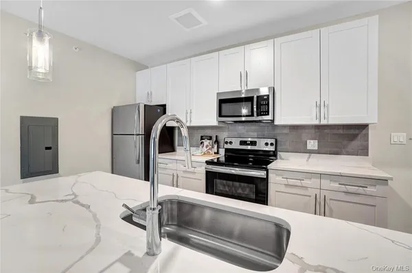 a kitchen with a refrigerator stove and microwave