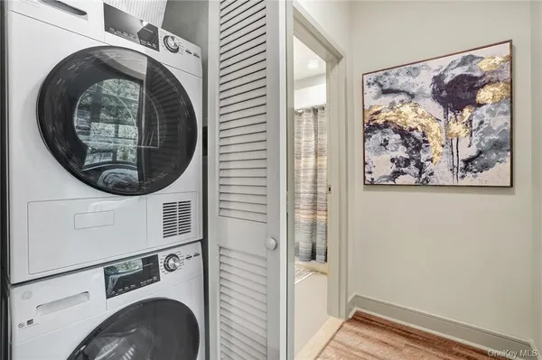 a view of a hallway with washer and dryer