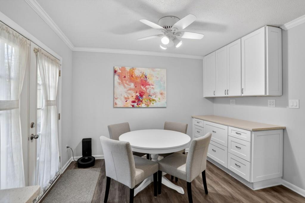 6900 Roswell Road, Unit L7 Atlanta, GA 30328 - Photo 11 of 25 a view of a dining room with furniture and wooden floor