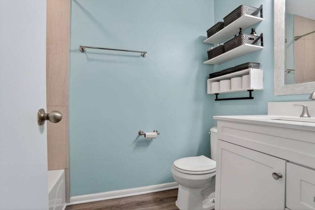 6900 Roswell Road, Unit L7 Atlanta, GA 30328 - Photo 19 of 25 a bathroom with a toilet sink and vanity