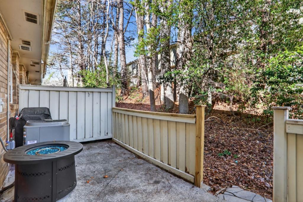 6900 Roswell Road, Unit L7 Atlanta, GA 30328 - Photo 25 of 25 a backyard of a house with fountain table and chairs