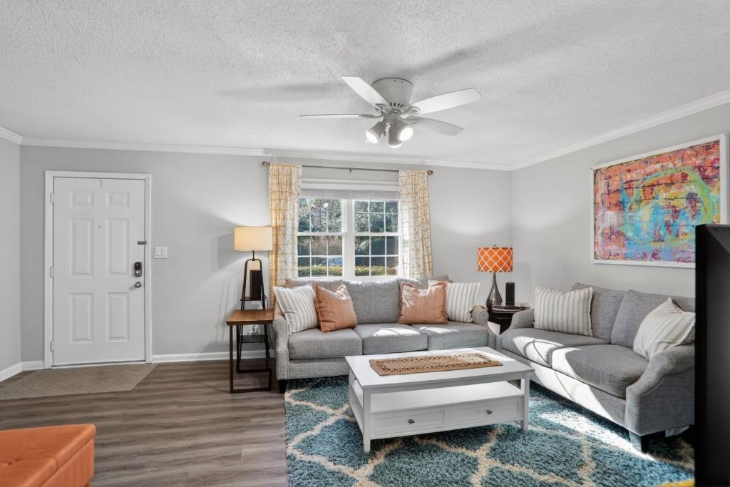 6900 Roswell Road, Unit L7 Atlanta, GA 30328 - Photo 4 of 25 a living room with furniture and a large window