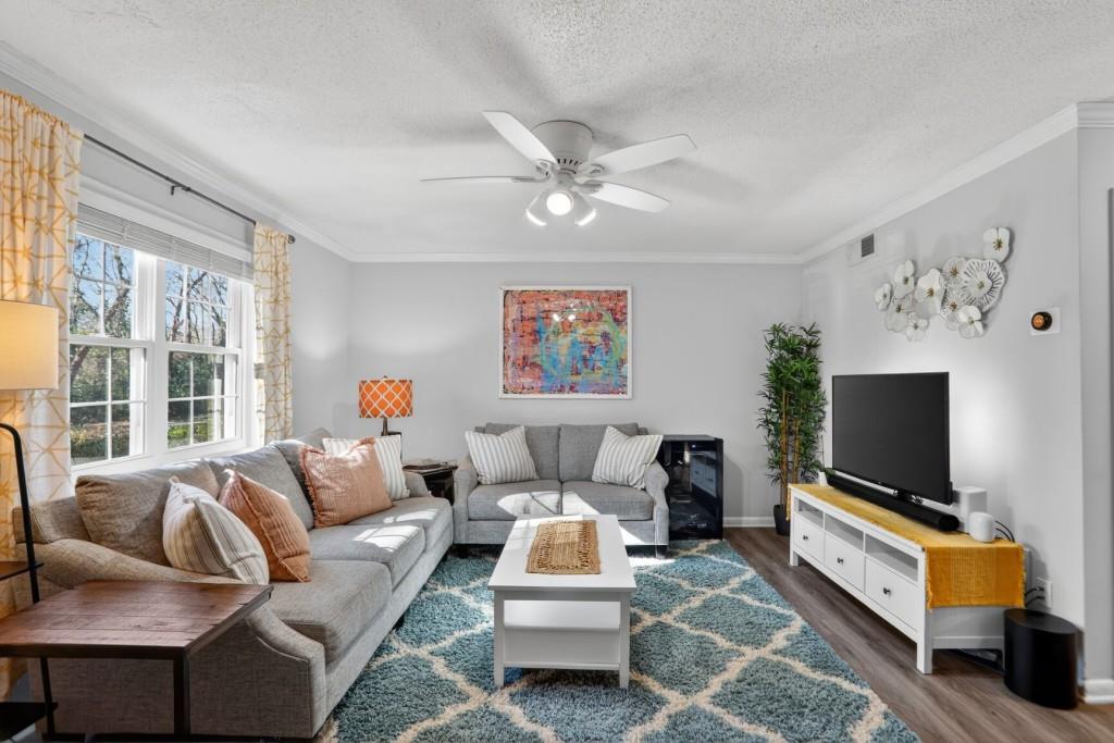 6900 Roswell Road, Unit L7 Atlanta, GA 30328 - Photo 6 of 25 a living room with furniture and a flat screen tv