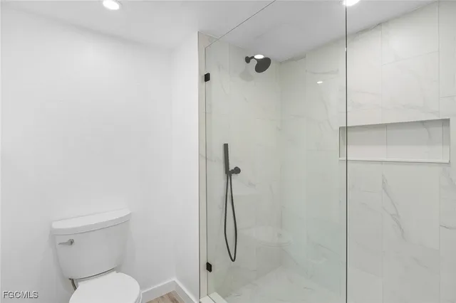 a bathroom with a toilet and a shower