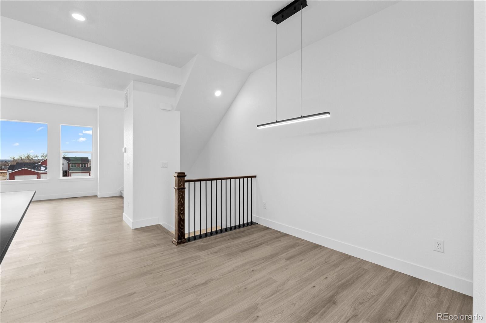 14281 Currant Street Broomfield, CO 80020 - Photo 12 of 23 a view of a hallway with wooden floor