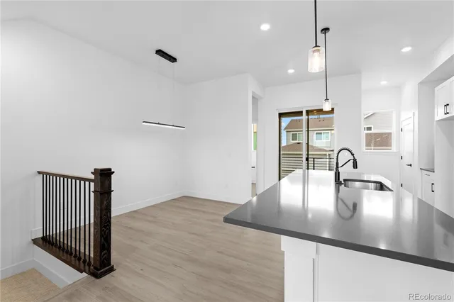 a kitchen with kitchen island a sink appliances and a counter top space